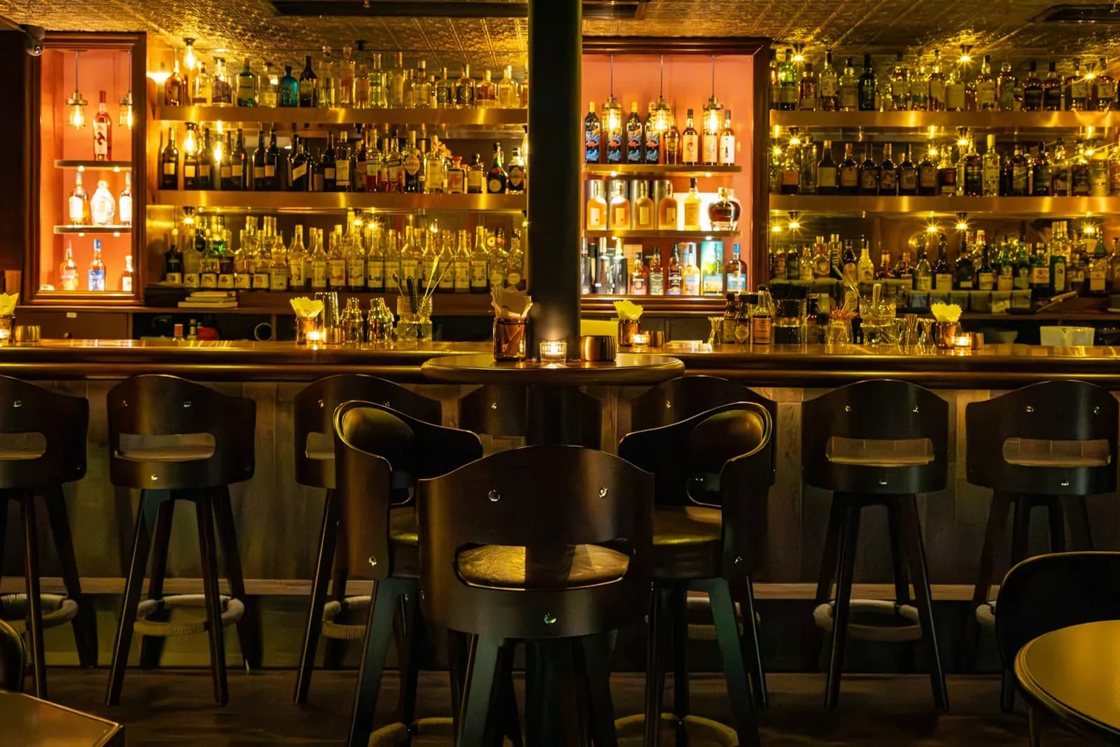 Hotel bar with stools and back-lit shelves