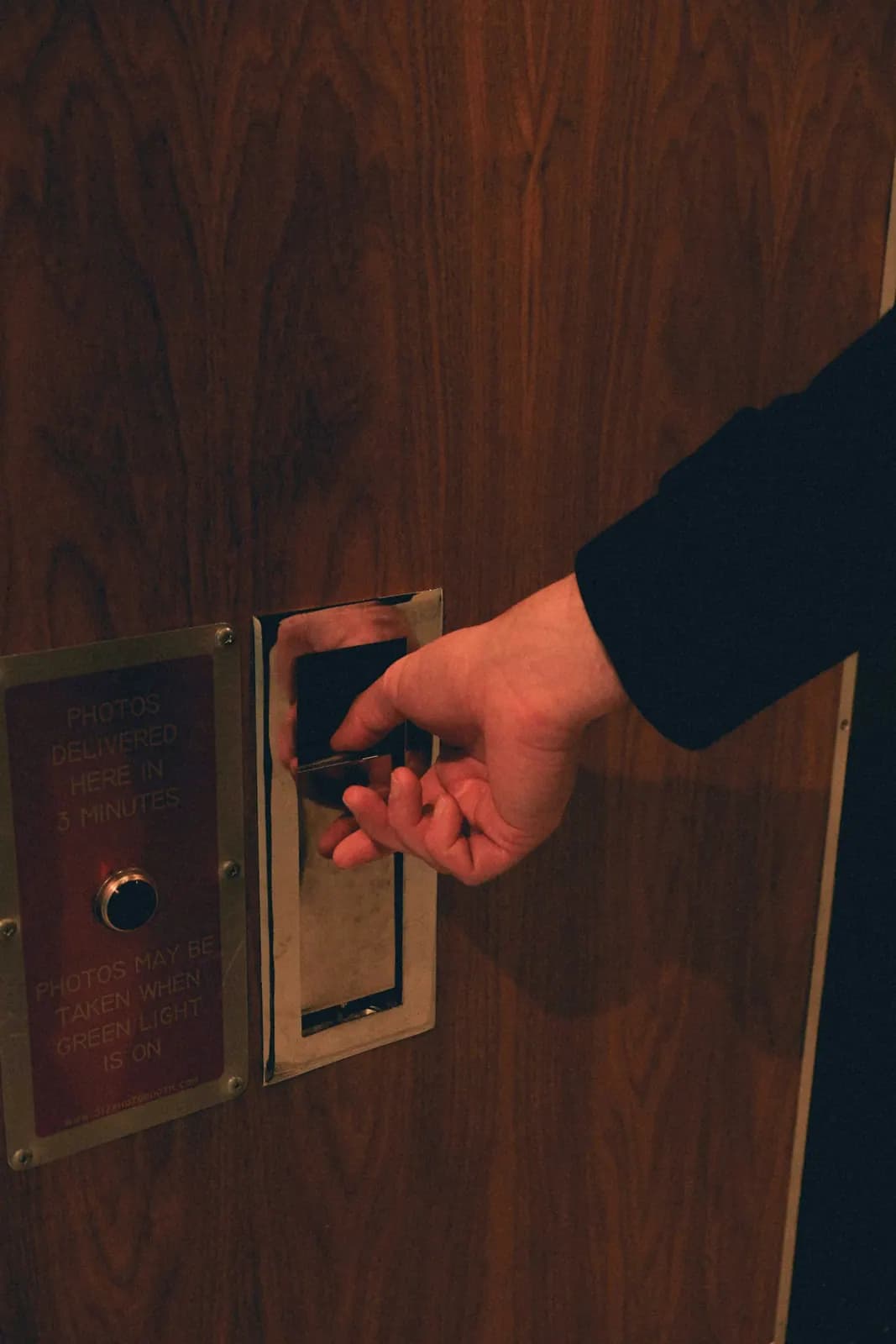 Guest holding a key card to a hotel room door lock