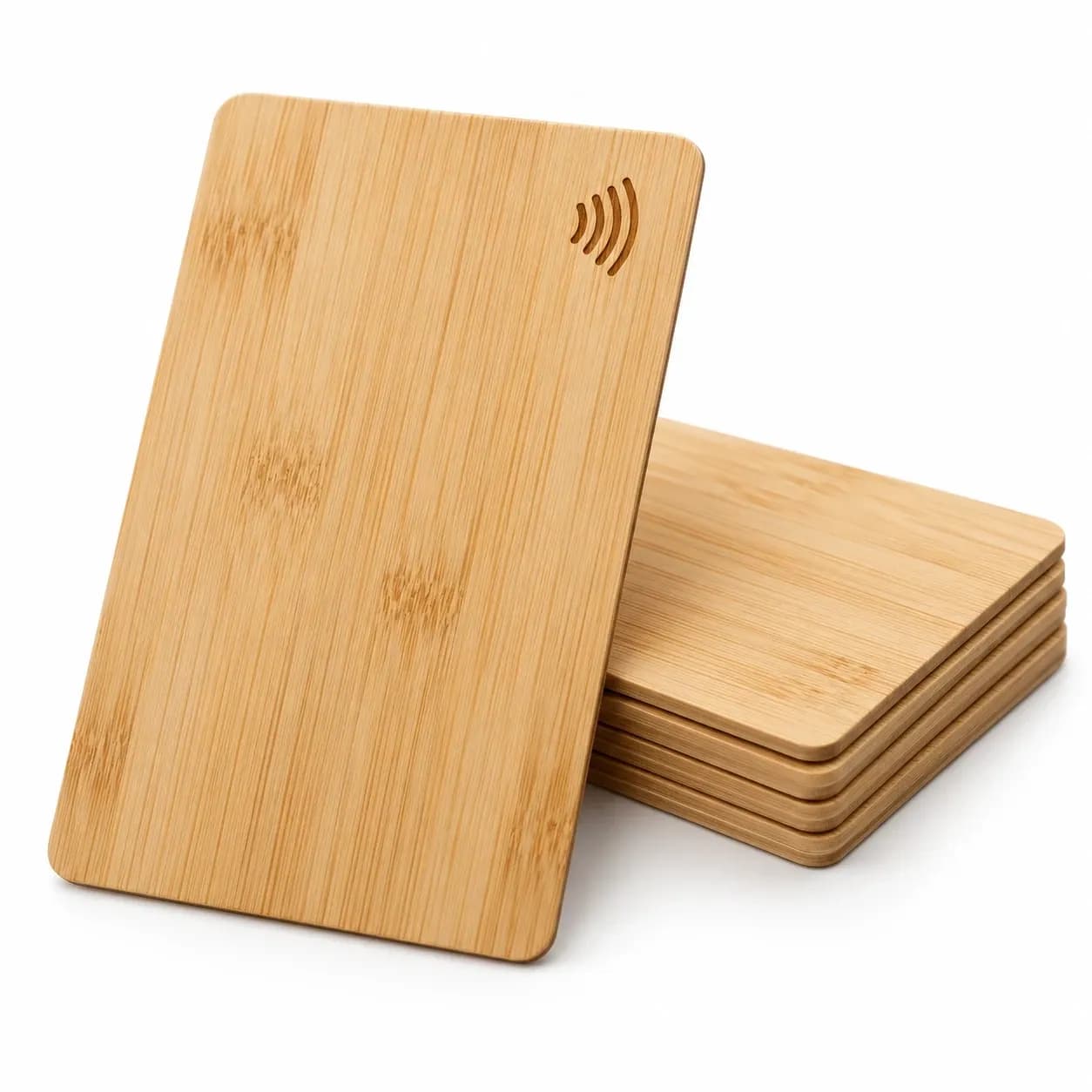 Bamboo RFID key card engraved with the contactless symbol, leaning on a stack