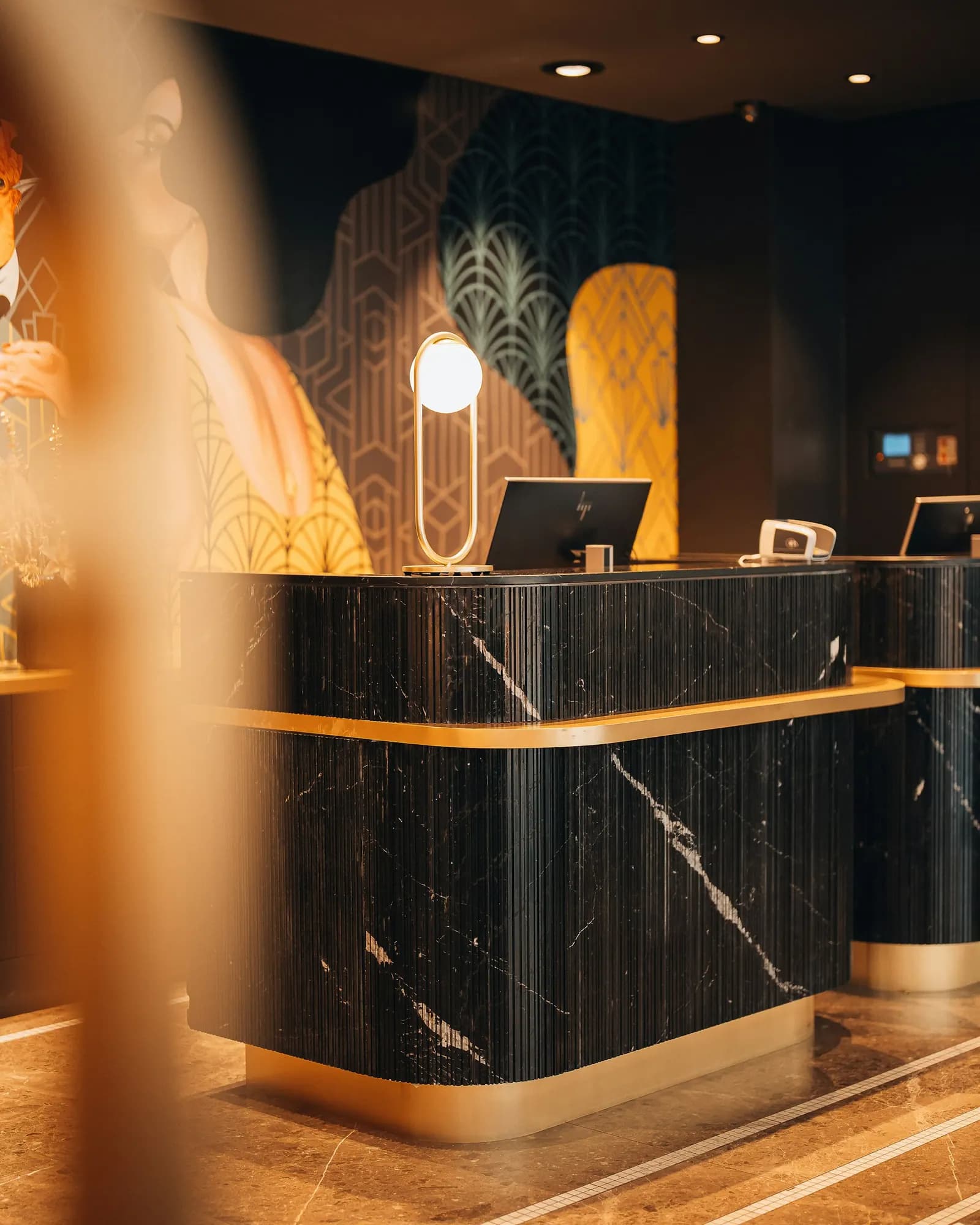 Marble and brass reception desk in a hotel lobby