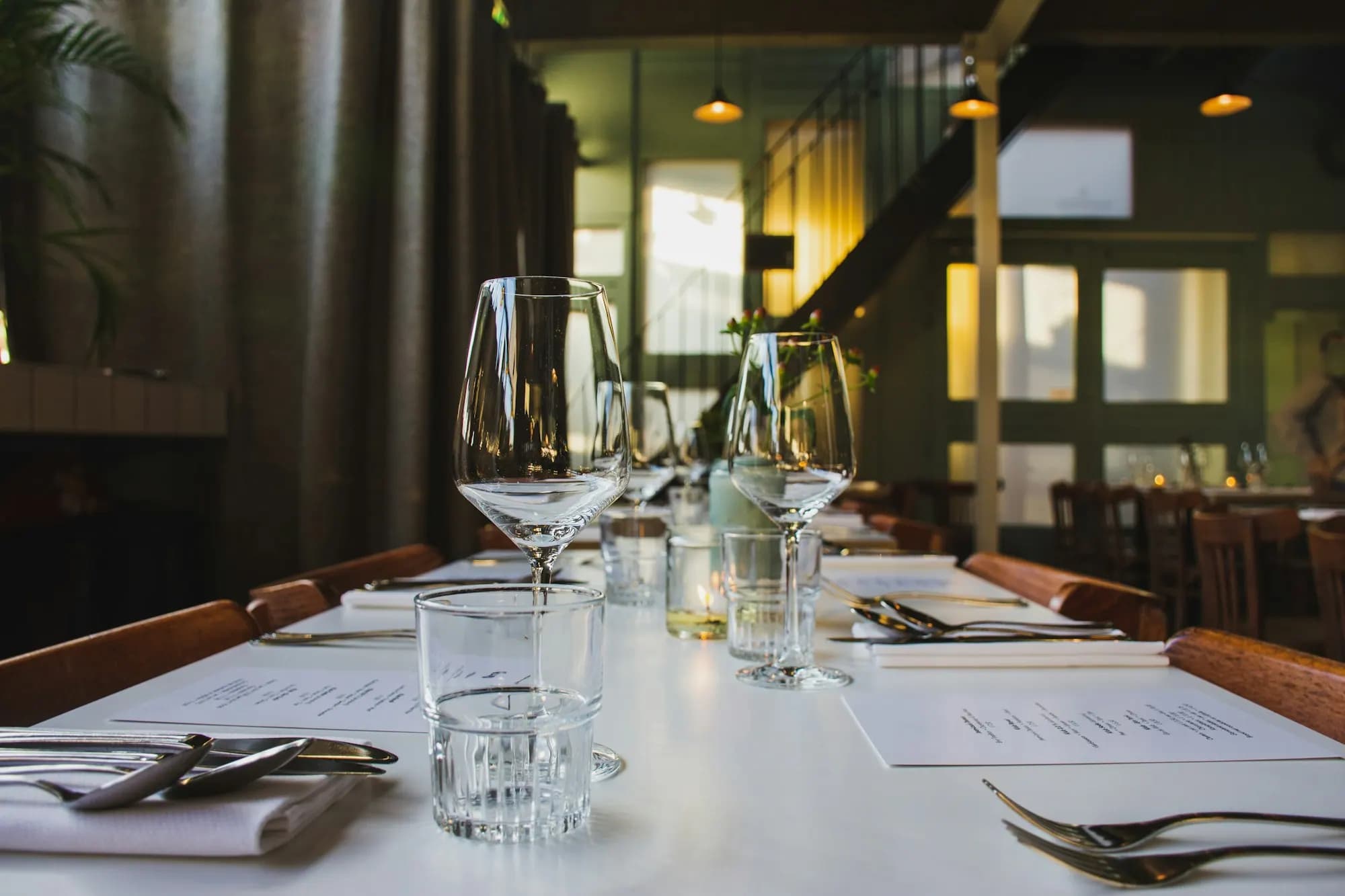 Restaurant table set with wine glasses