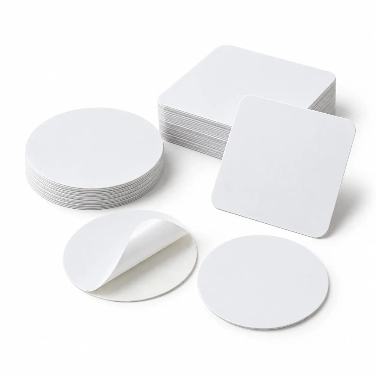 Round and square white NFC stickers, one peeling from its backing